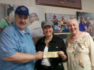 PDG Wayne Faber and Lion Barbara Faber present a check for $550 to Susan King Camp Dogwood Director