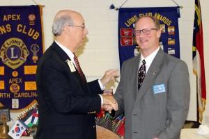 PDG Lion Andy Lilliston presents Lion John Lynde with the Past President pin