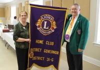 DGE Mary Boehm and DG Ron Beltran with the district club banner