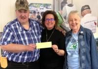 Check presented to Susan King, Directory of Camp Dogwood