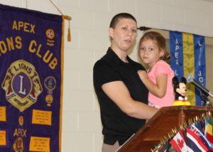 Amanda Lunn holds Amber while speaking at the Apex Lions Club