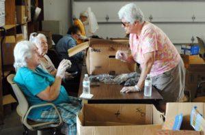 Lion Barbara Faber at work sorting through eyeglass donations