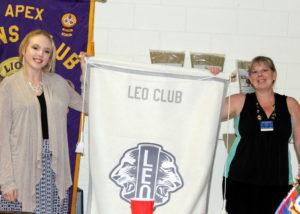 Samantha and Joelle hold up Leo Banner