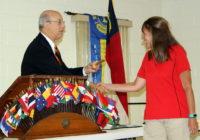 PDG Andy Lilliston hands Lion Jolene the gavel