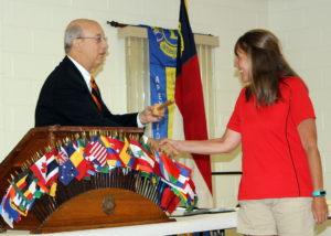 PDG Andy Lilliston hands Lion Jolene the gavel