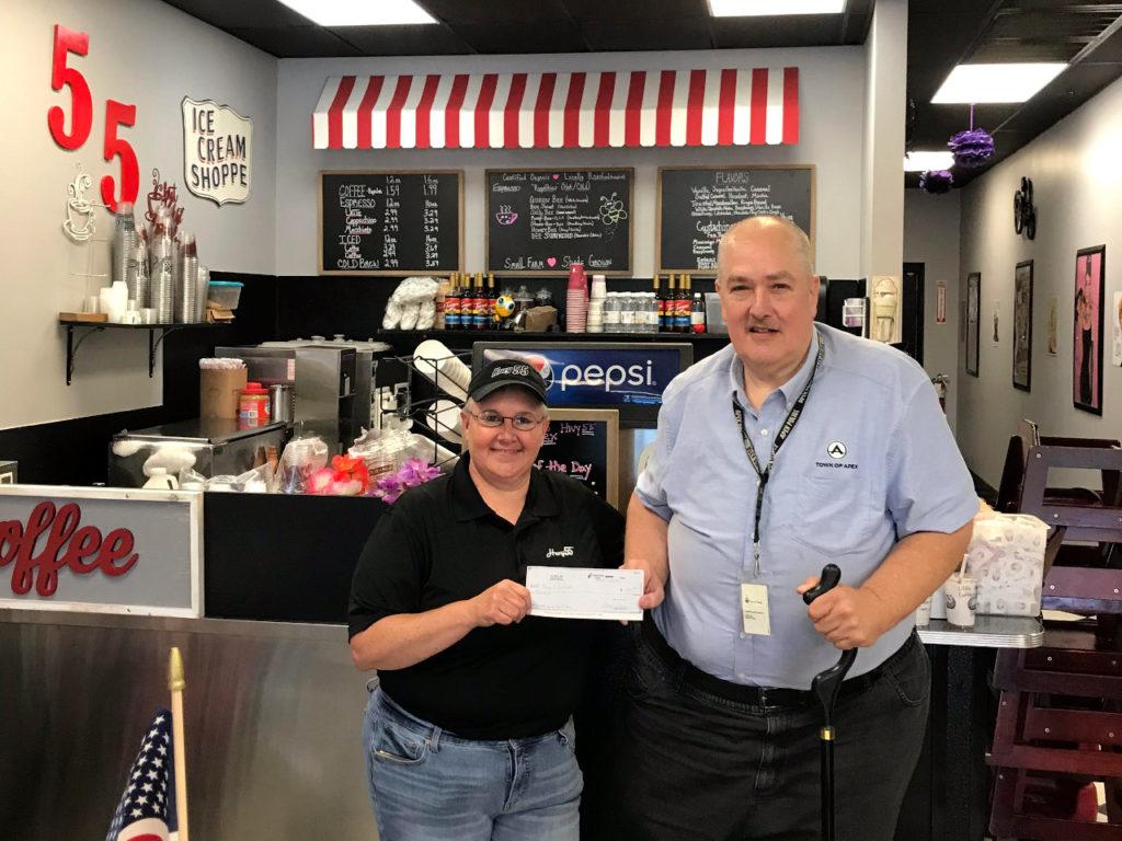 Hwy 55 presents a check for $1000