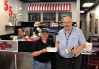 Hwy 55 presents a check for $1000